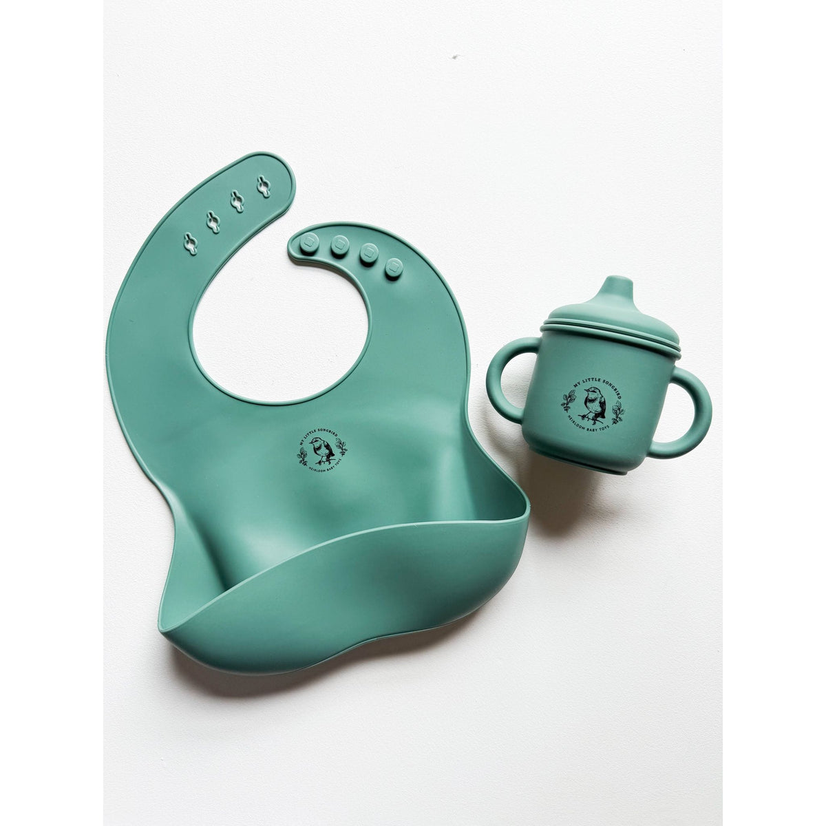 Silicone bib by ShopMyLittleSongbird with adjustable neck strap and food-catching pocket for easy feeding cleanup.