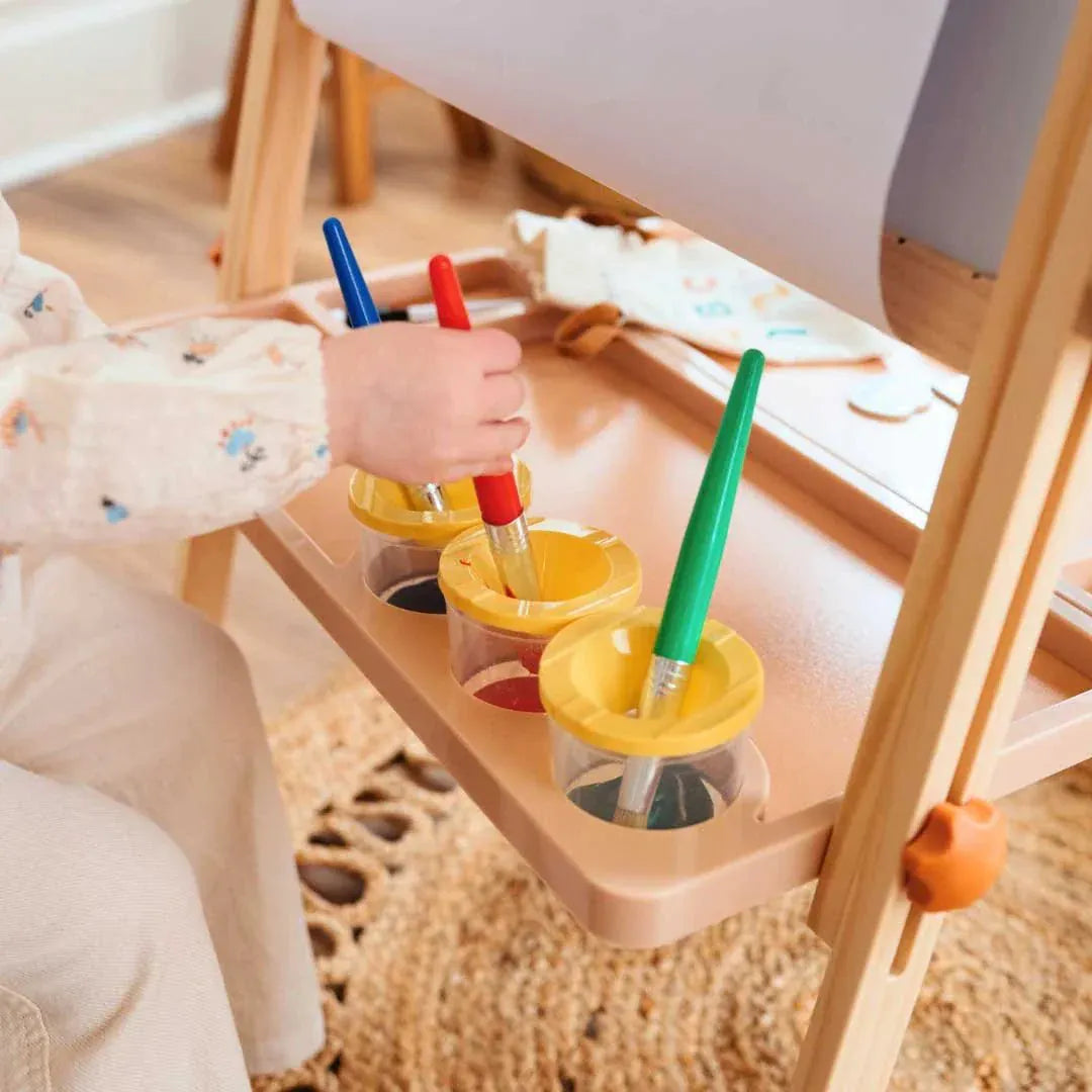 Tiny Land Kids Easel with caramel-colored magnetic surfaces and art clips, designed for children’s creative play and drawing activities.