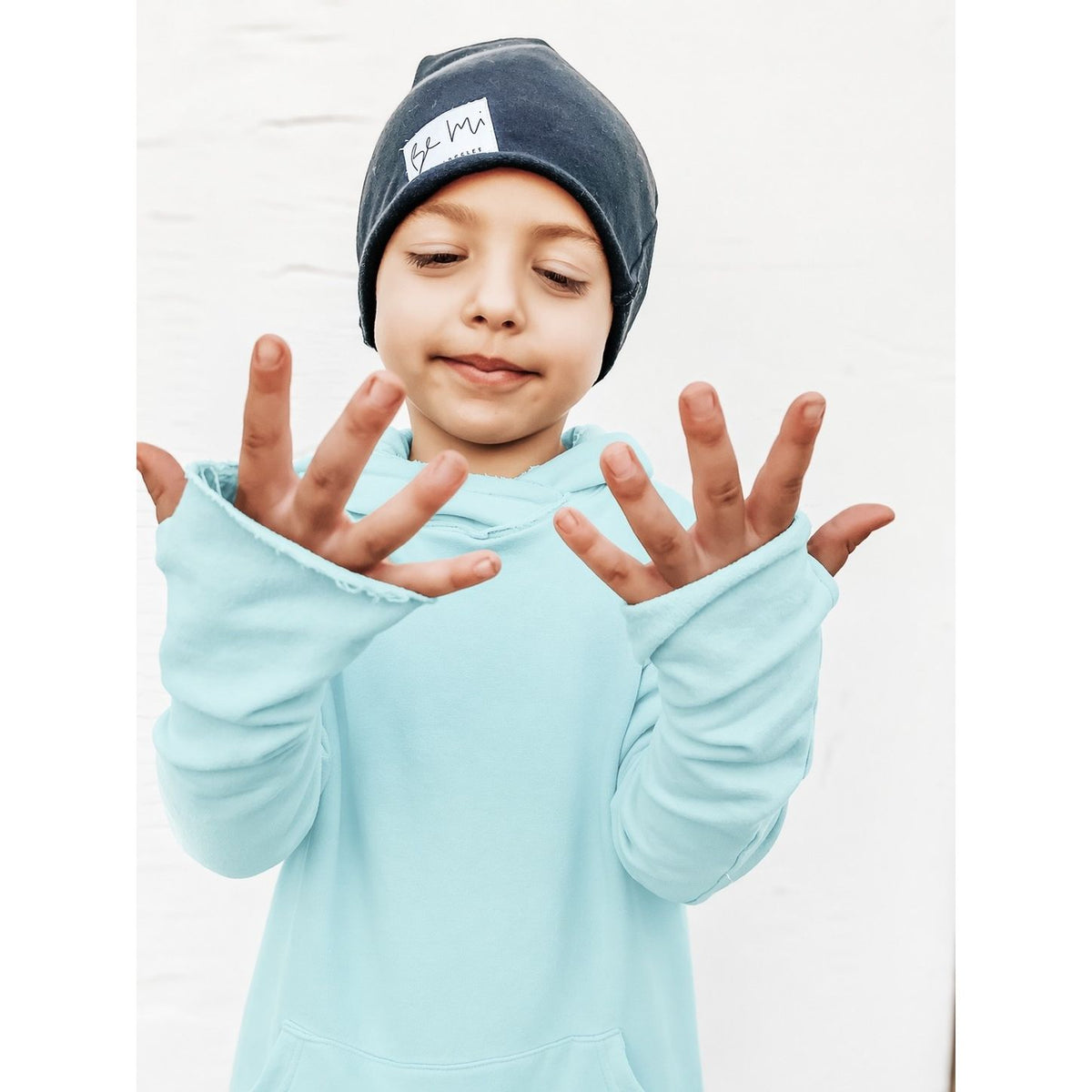 Organic Benji Hoodie Aqua by Be Mi Los Angeles, a cozy sweatshirt in vibrant aqua, displayed on a clean background.