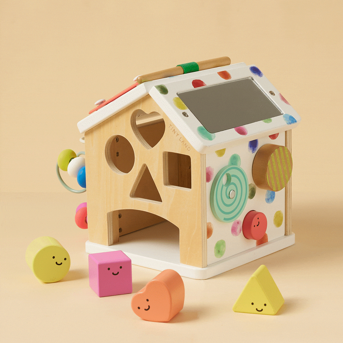 Tiny Land® Cottage Activity Cube in rainbow colors with engaging shapes and interactive features for toddlers.