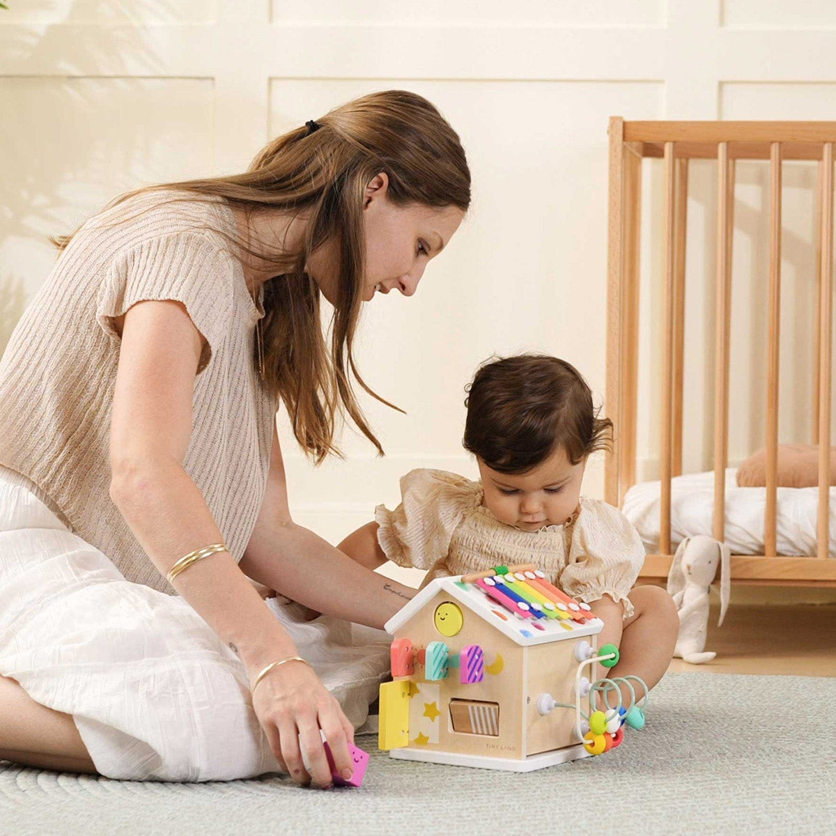 Colorful Tiny Land® Cottage Activity Cube with rainbow design, featuring engaging toys and activities for children.