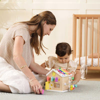 Colorful Tiny Land® Cottage Activity Cube with rainbow design, featuring engaging toys and activities for children.