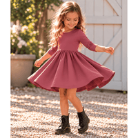 Girl wearing the Nova organic cotton twirl dress in muted berry, featuring a full circle skirt, round neckline, and delicate ruched sleeves.