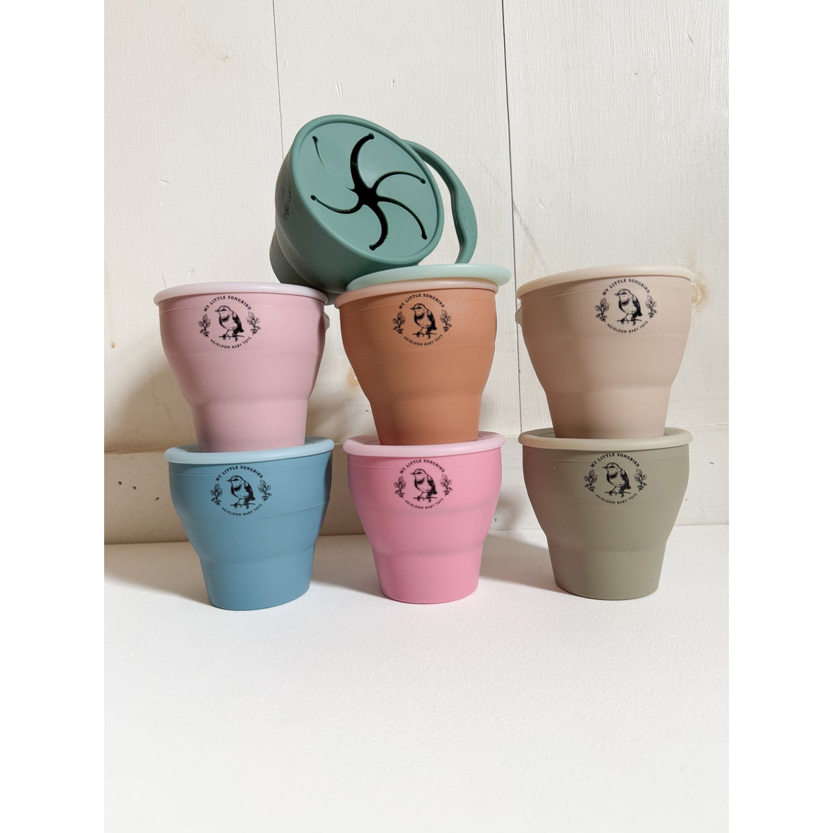 Two collapsible silicone snack cups with colorful lids, designed for children, from ShopMyLittleSongbird.