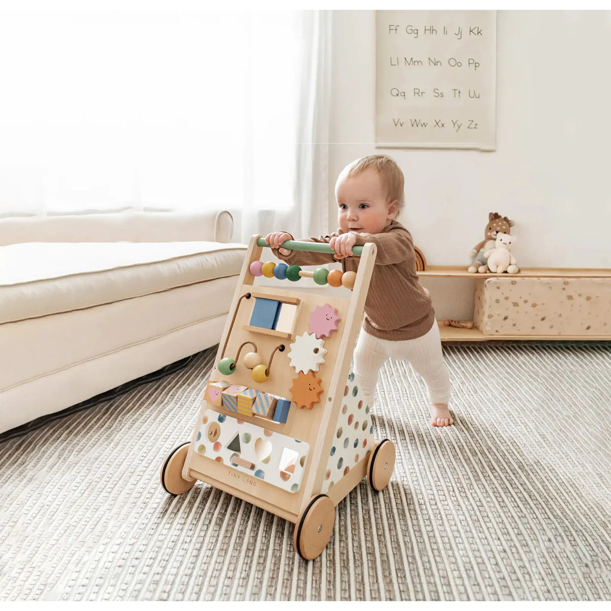Natural wooden baby walker from Tiny Land INC with smooth finish, designed to help babies learn to walk safely and comfortably.