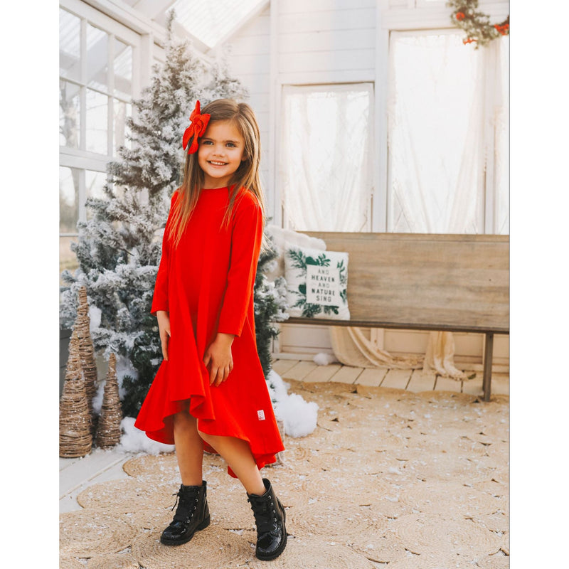 Little girl wearing festive red twirl dress