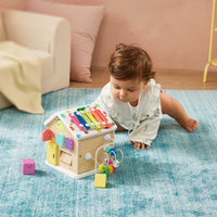 Tiny Land® Cottage Activity Cube in rainbow colors featuring interactive shapes, gears, and sliding elements for toddler play.