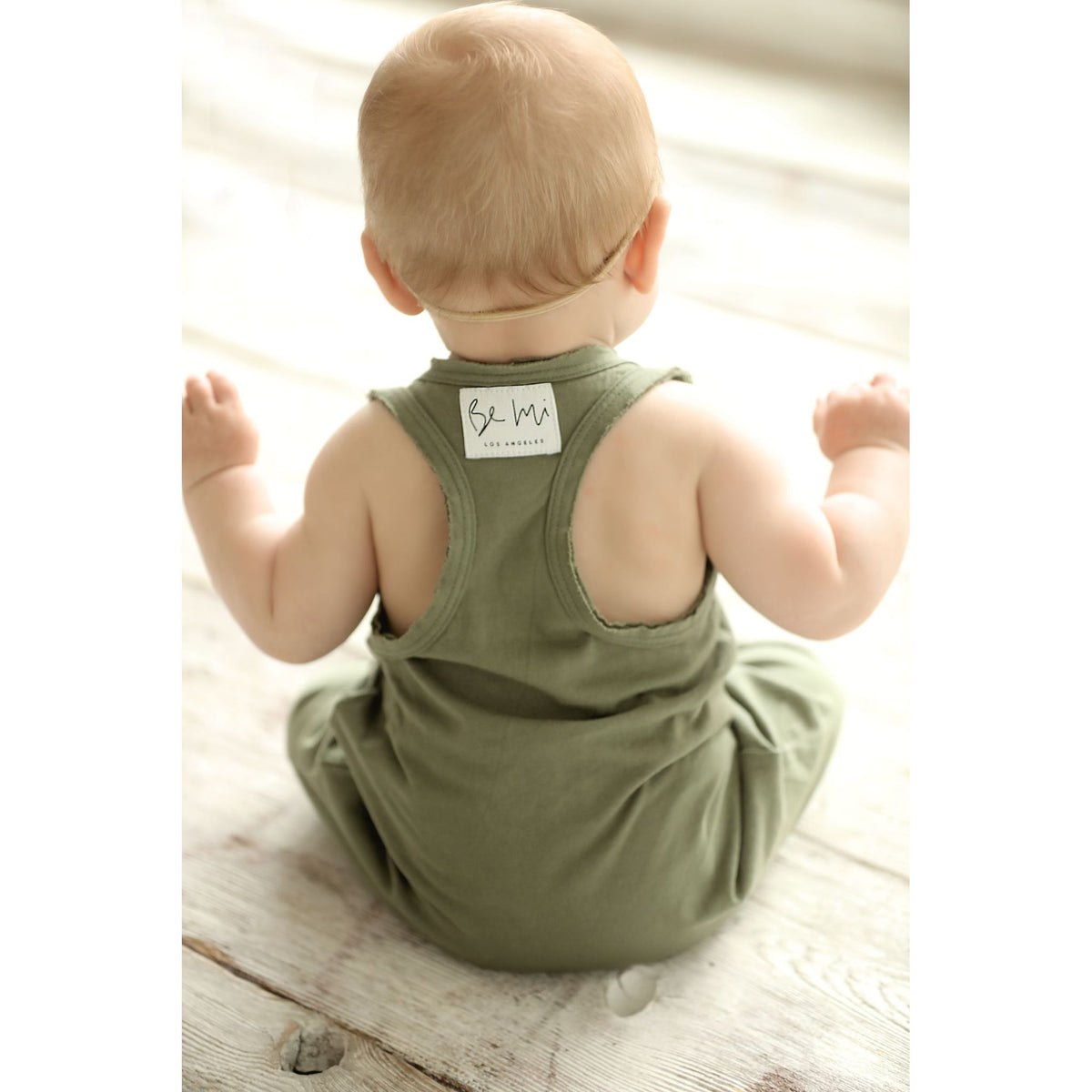 Be Mi Los Angeles olive romper featuring a relaxed fit, short sleeves, and stylish design, perfect for casual wear.