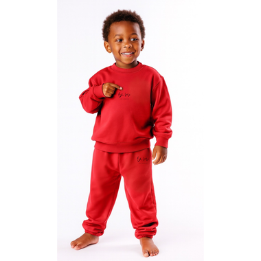 Child wearing a red outfit with branding on a white background