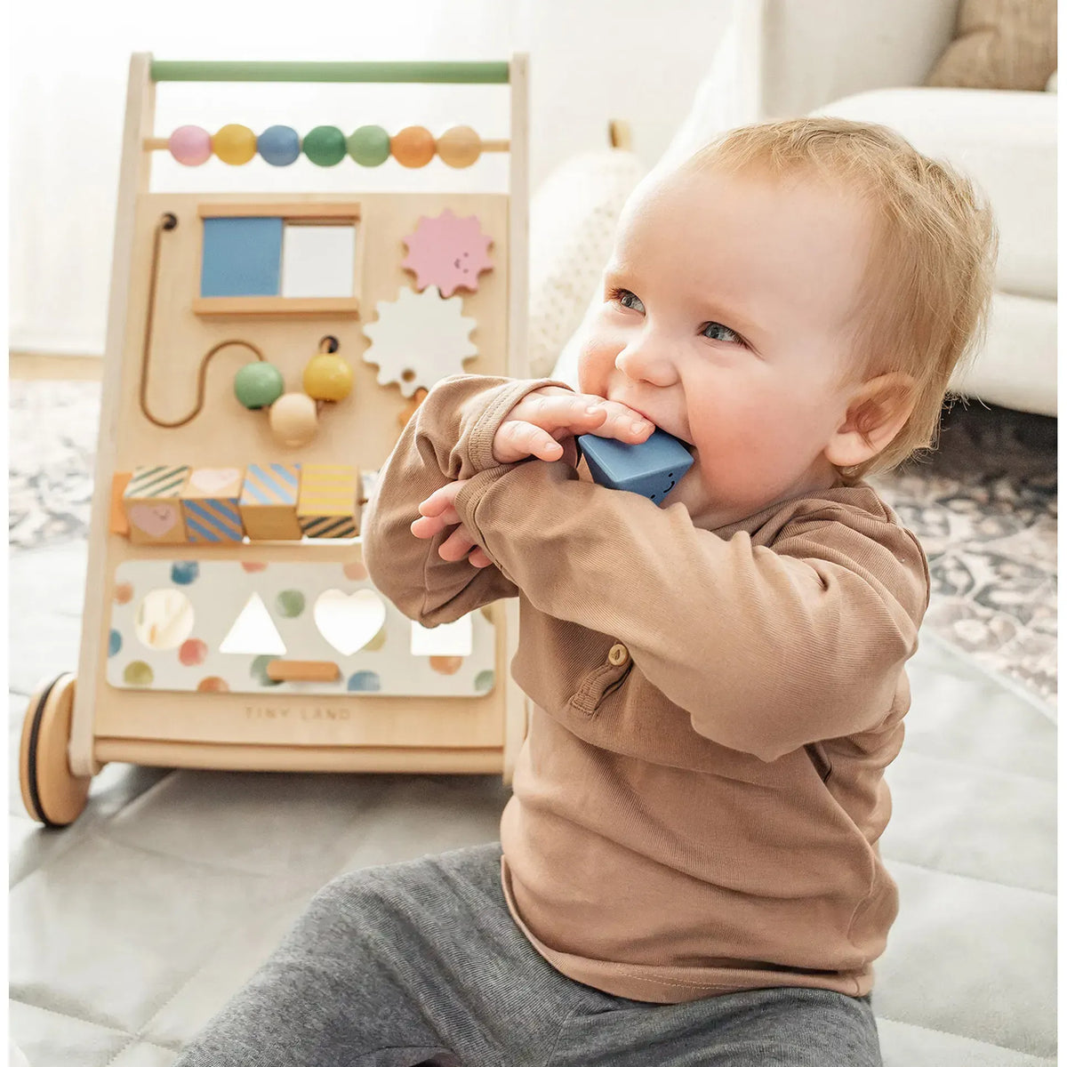 Tiny Land® natural wooden baby walker with four wheels and handles, designed for infants learning to walk.