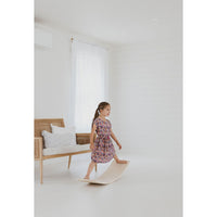 Child balancing on a ShopMyLittleSongbird balance board toy, designed for stability and fun indoor play.