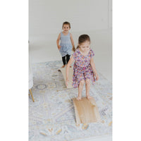 Children's balance board rocker toy by ShopMyLittleSongbird featuring a colorful, curved wooden design for active play.