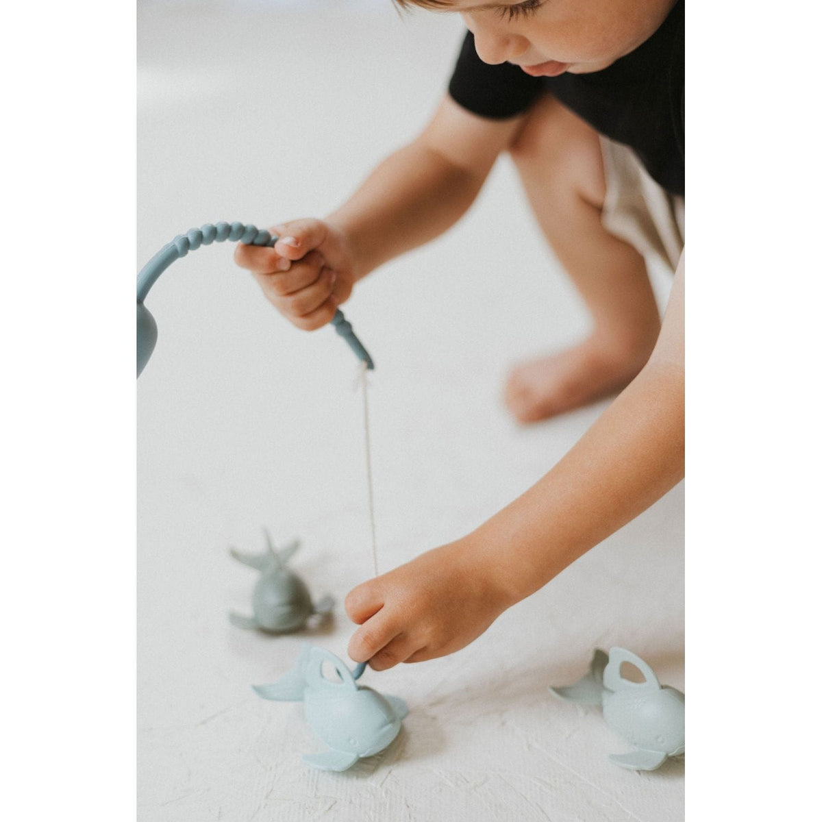 Colorful silicone fishing set with toy fishing rods and fish, perfect for kids' play and learning about fishing.