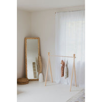 Wooden toddler clothes rack from ShopMyLittleSongbird featuring a lightweight, natural wood design for children's clothing organization.