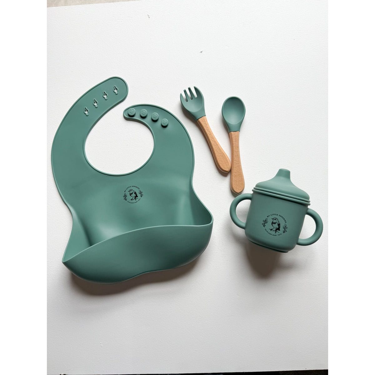 ShopMyLittleSongbird silicone bib with adjustable neck strap and spill-resistant front for easy cleaning during mealtime.