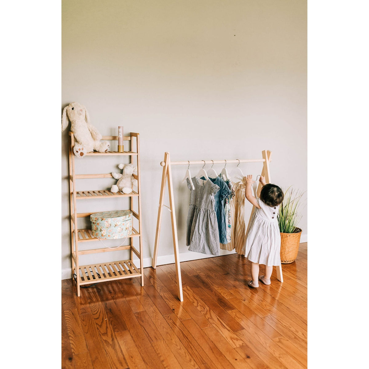 Wooden toddler clothes rack from ShopMyLittleSongbird, featuring a sturdy wooden frame for hanging children's clothes and toys.
