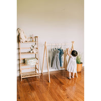 Wooden toddler clothes rack from ShopMyLittleSongbird, featuring a sturdy wooden frame for hanging children's clothes and toys.