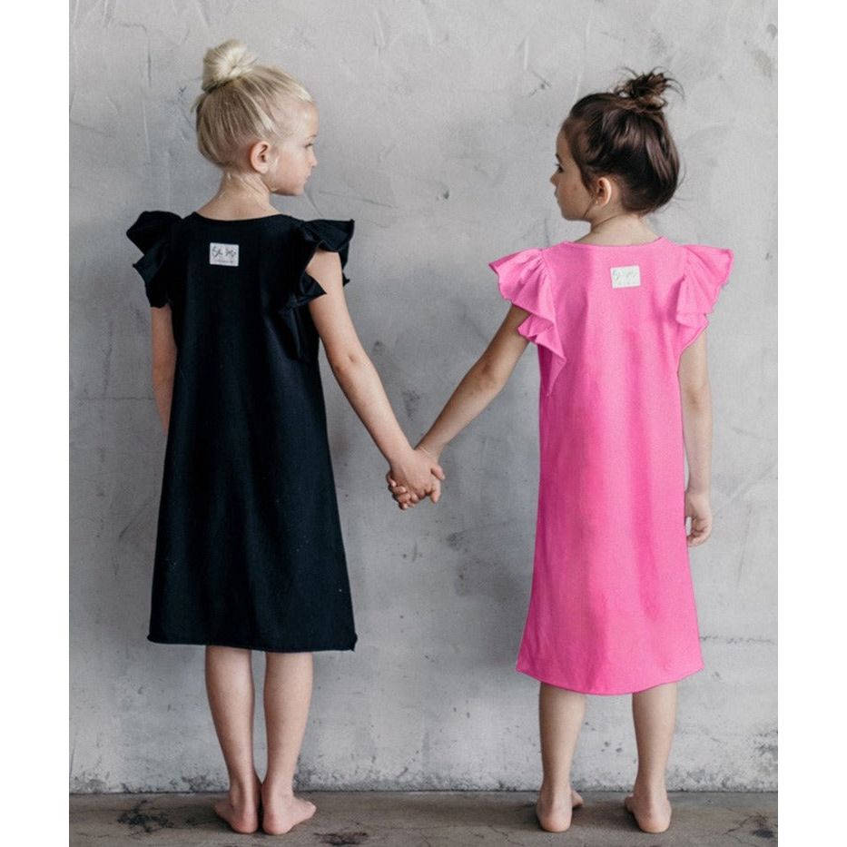 Be Mi Los Angeles Valentina Ruffle Dress shown on a model with flowing fabric and ruffle details, perfect for stylish occasions.