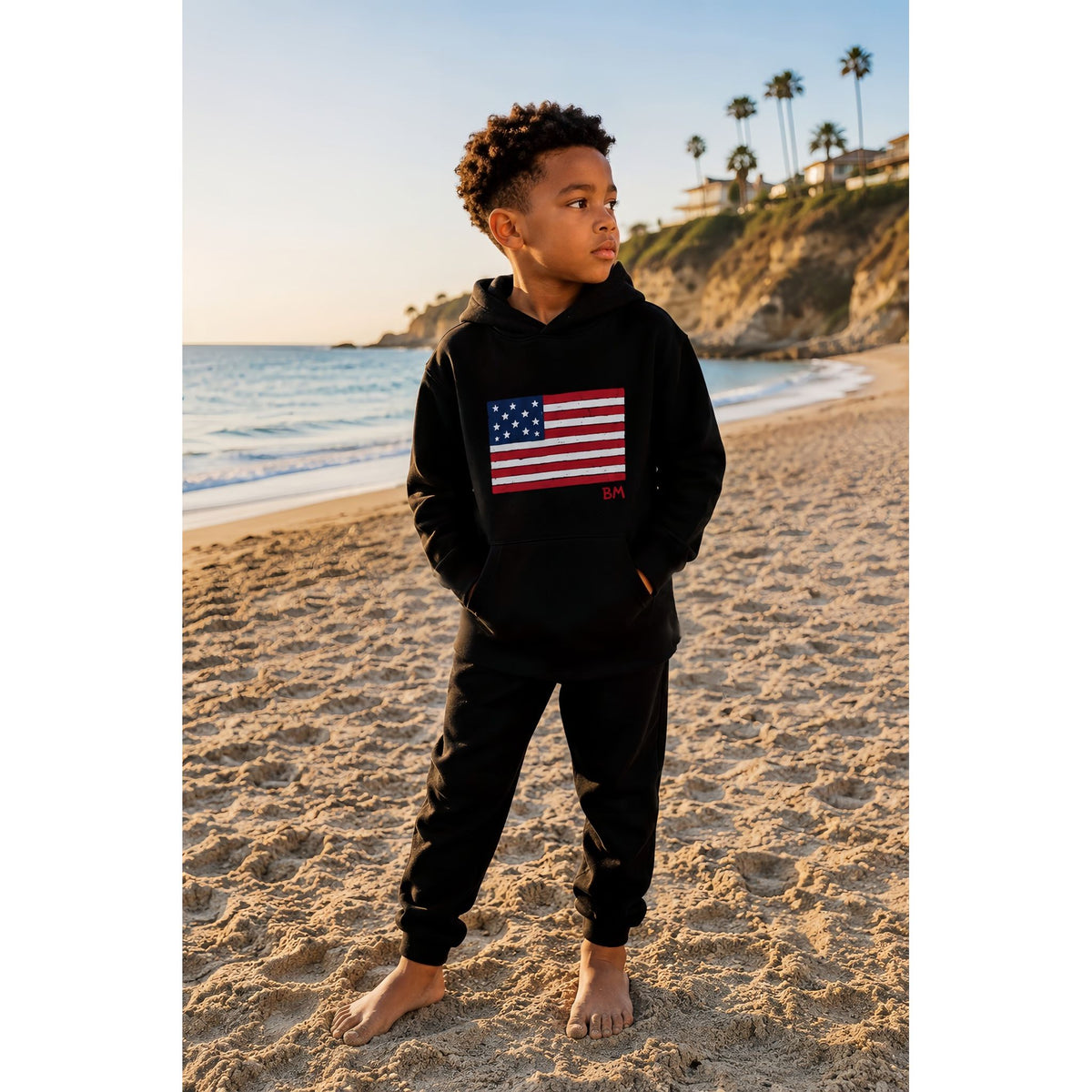 Black organic Benji Flag hoodie by Be Mi Los Angeles, showing front view with flag graphic and hoodie details.