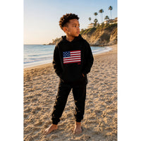 Black organic Benji Flag hoodie by Be Mi Los Angeles, showing front view with flag graphic and hoodie details.