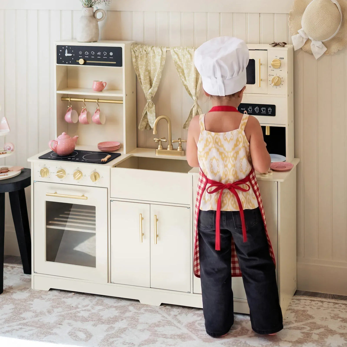Tiny Land® wooden play kitchen in cream with pretend stove and sink for kids, perfect for imaginative cooking play.