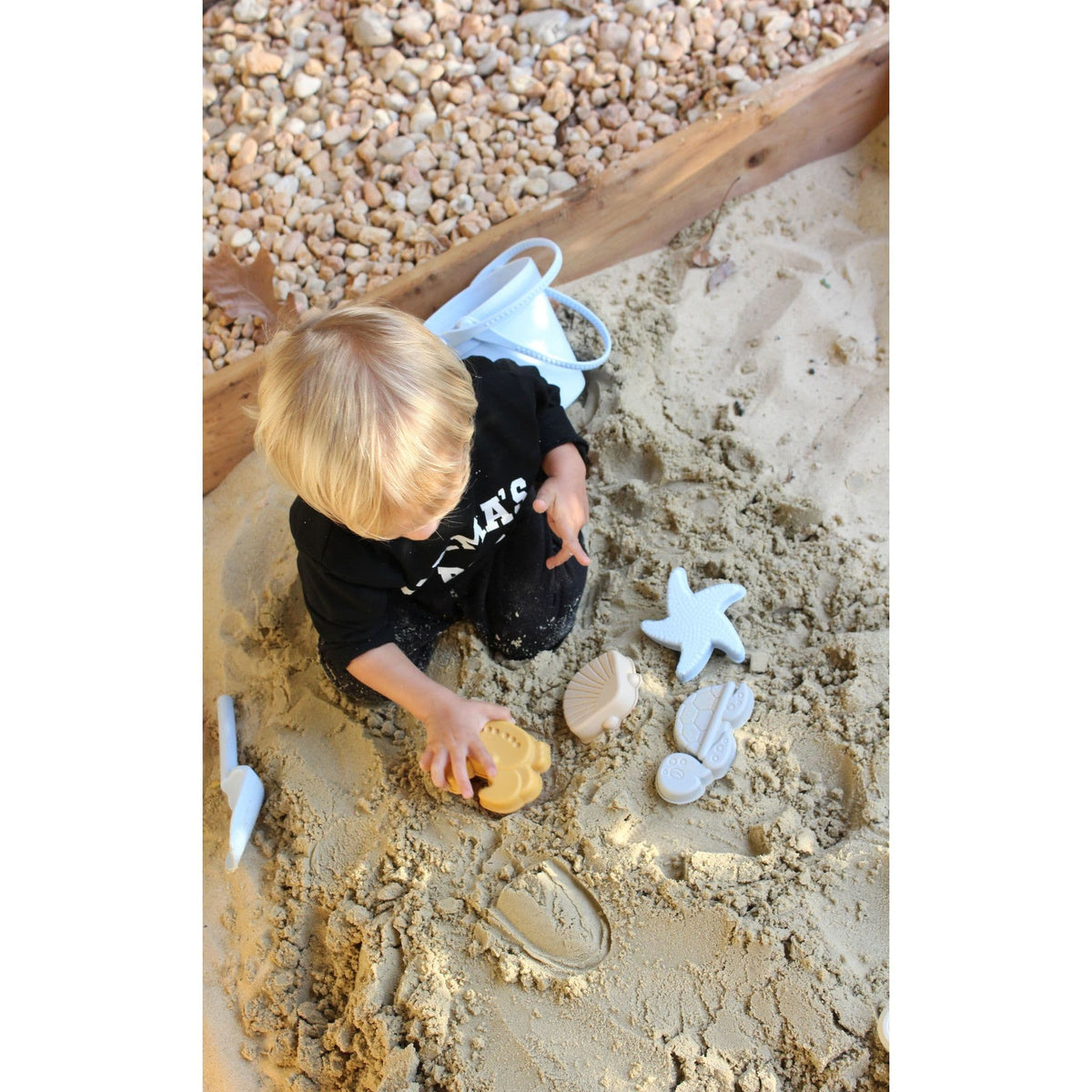 Silicone sand toy bucket with colorful toys and shovel for kids, ideal for outdoor play and sandcastle building.