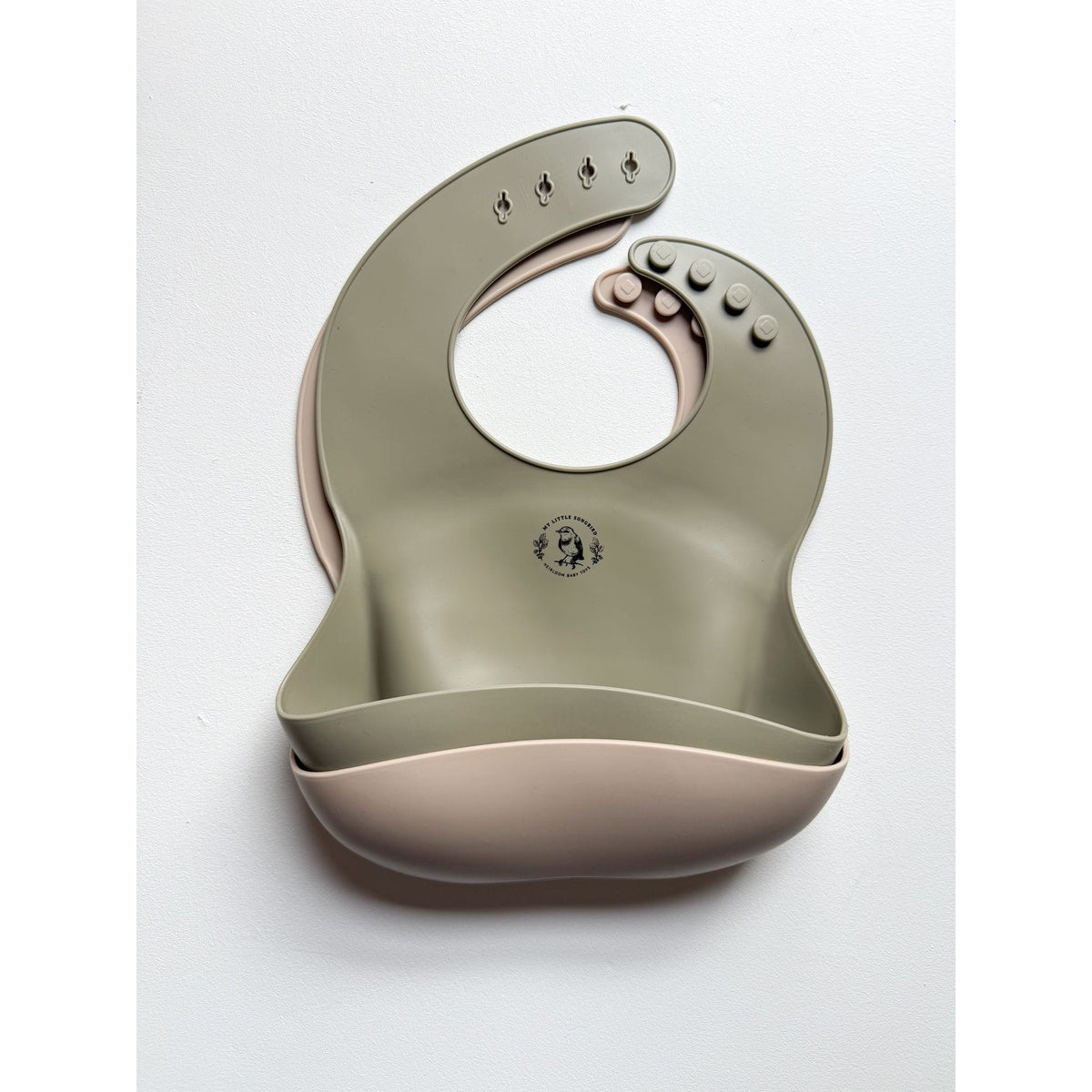 ShopMyLittleSongbird silicone bib showing waterproof, flexible design with a pocket for catching messes, ideal for feeding babies.