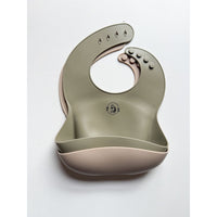 ShopMyLittleSongbird silicone bib showing waterproof, flexible design with a pocket for catching messes, ideal for feeding babies.