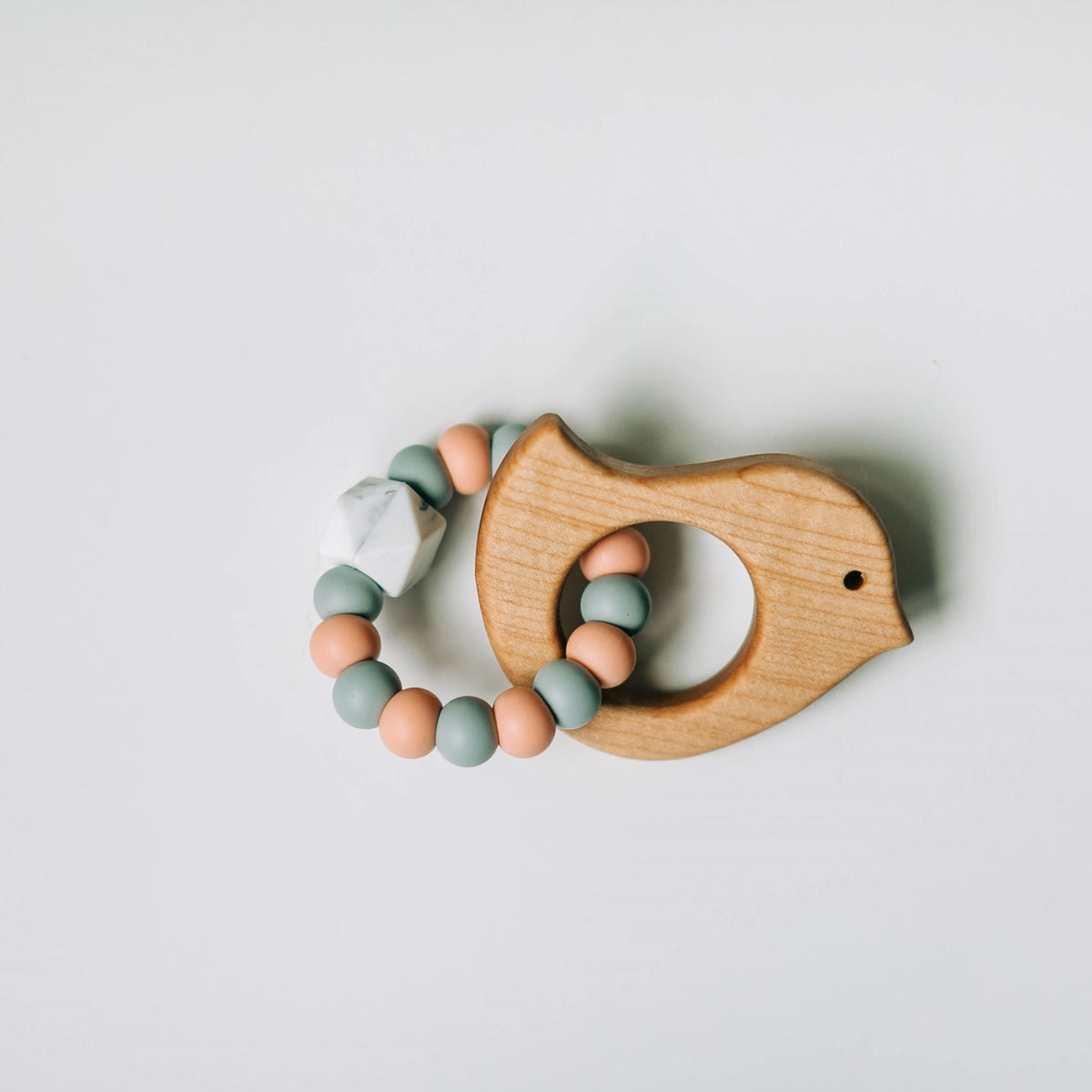 Wooden teether with silicone ring for babies, natural and safe teething toy from ShopMyLittleSongbird, showing the teether and silicone ring.