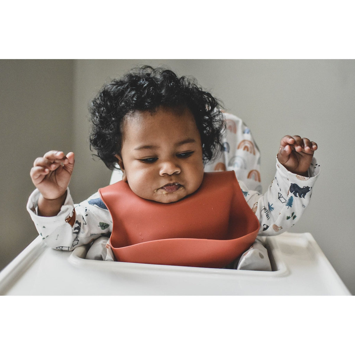 Silicone baby bib from ShopMyLittleSongbird with adjustable neck strap and colorful design to keep clothes clean during mealtime.