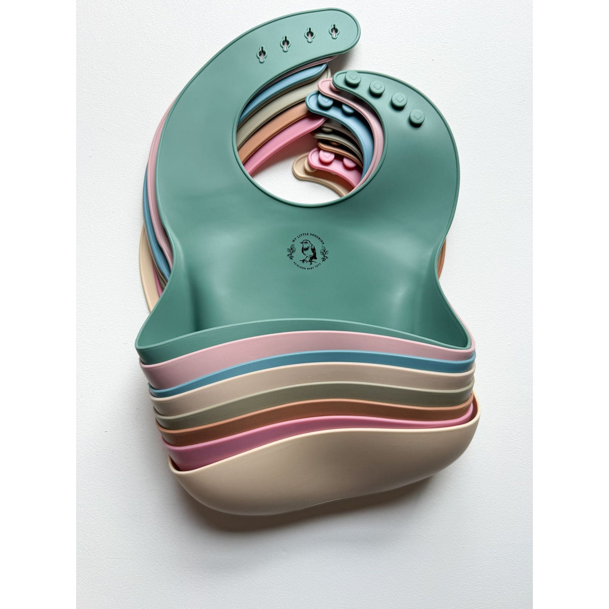 Silicone bib from ShopMyLittleSongbird with a colorful, waterproof design, featuring a pocket to catch crumbs during feeding.