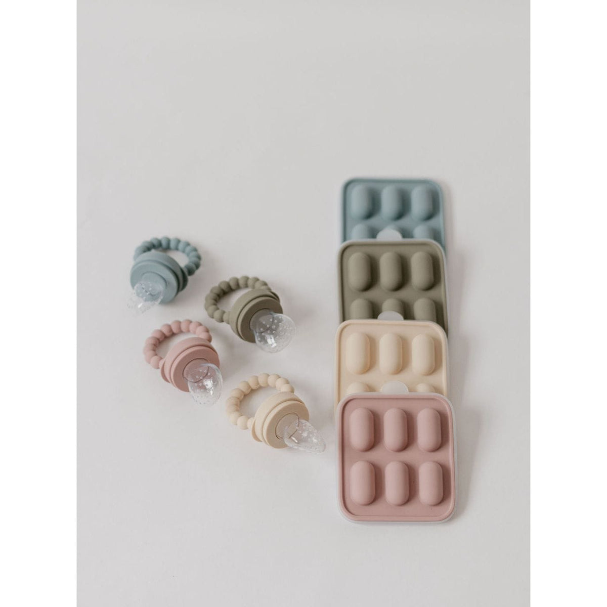 Silicone fruit feeder and ice tray set by ShopMyLittleSongbird, featuring colorful feeders and flexible trays for freezing fruit and ice.