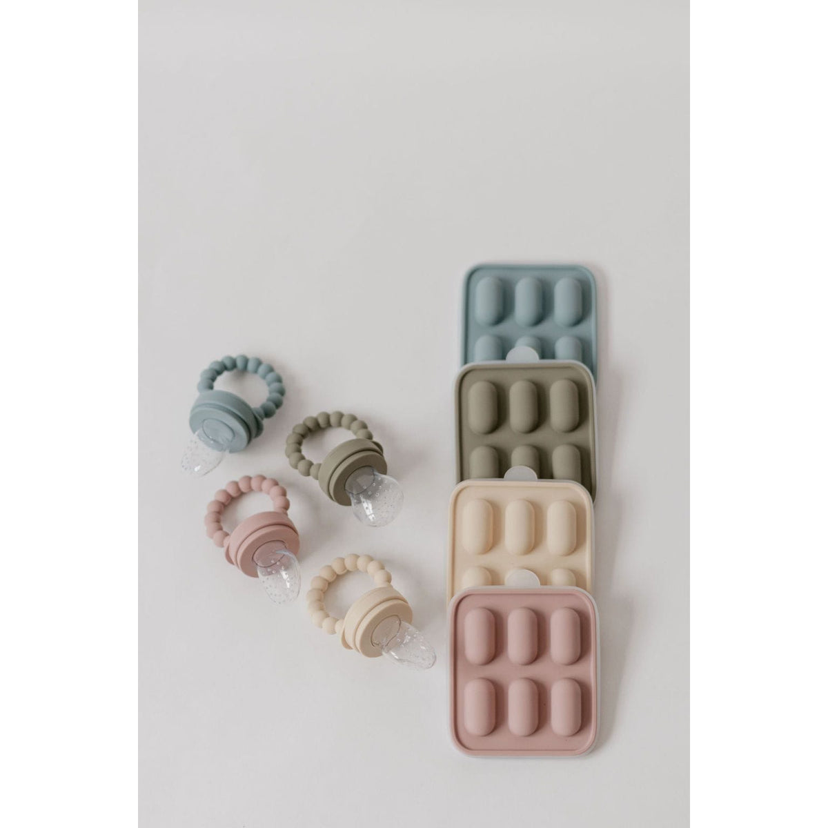 Silicone fruit feeder and ice tray set with colorful silicone compartments for safe food and ice storage.