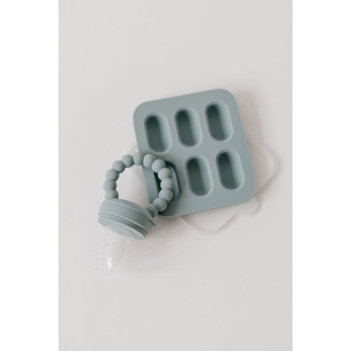 Silicone fruit feeder and ice tray set by ShopMyLittleSongbird with colorful silicone parts on a white background.