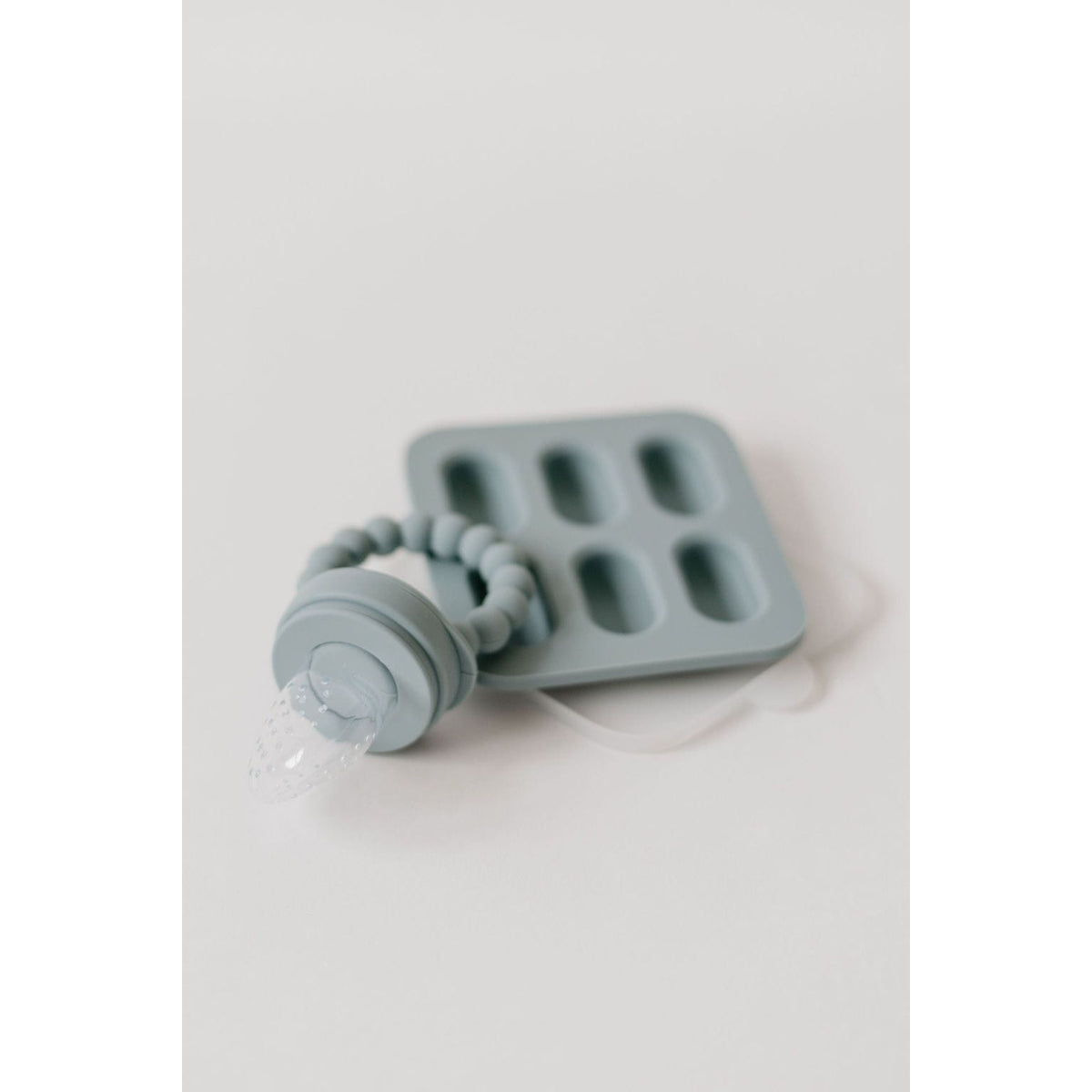 Silicone fruit feeder and ice tray set by ShopMyLittleSongbird with colorful silicone components on a white background.