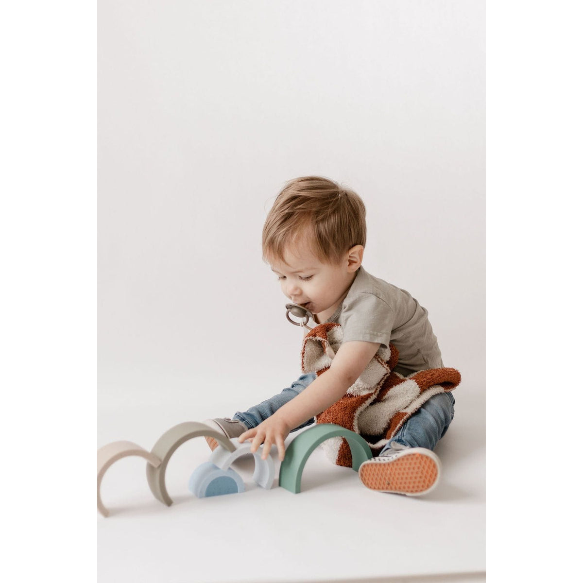 Colorful silicone stacking rainbow toy by ShopMyLittleSongbird with curved, vibrant arches for developmental play.
