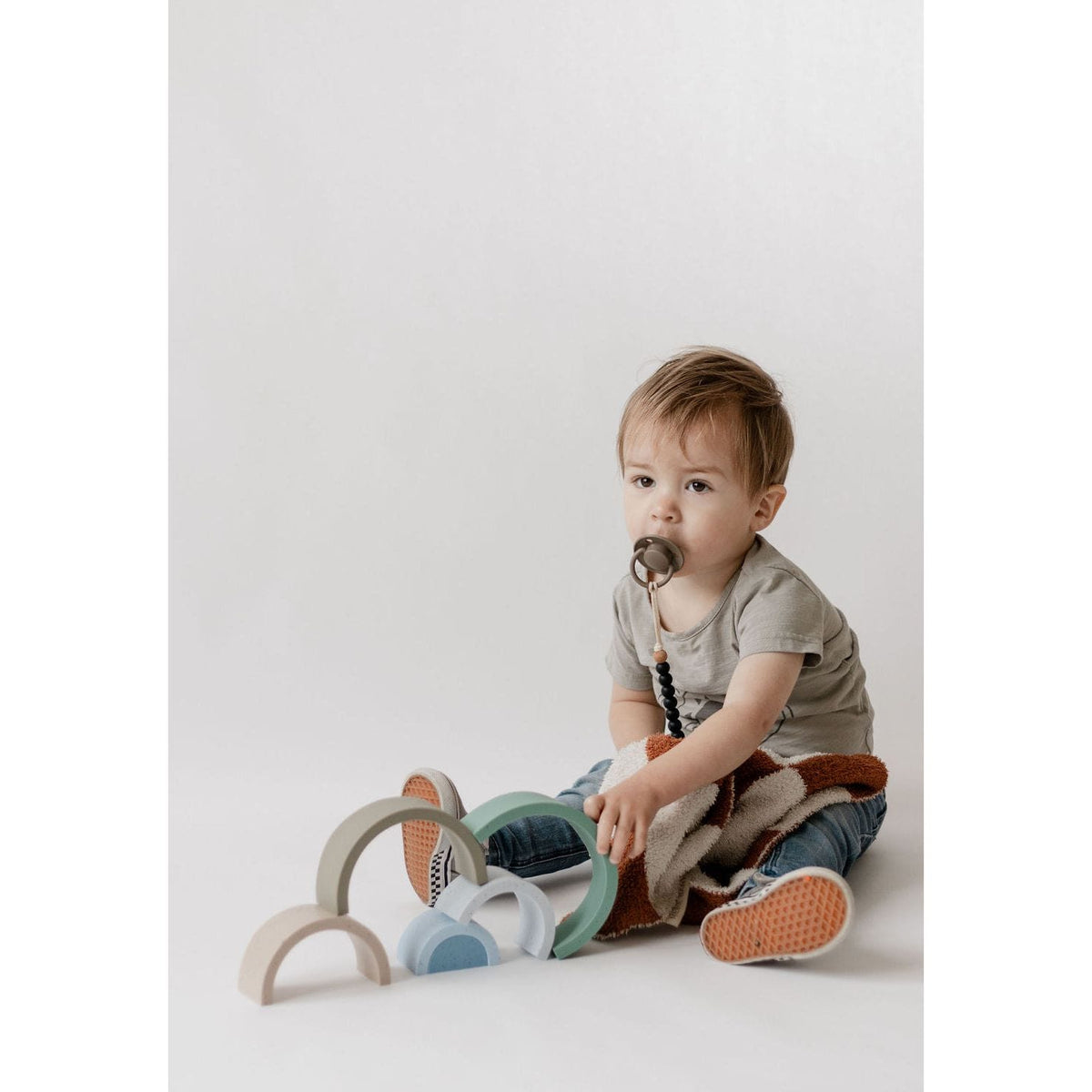Colorful silicone stacking rainbow toy by ShopMyLittleSongbird with vibrant, smooth, and flexible arc-shaped pieces for creative play.