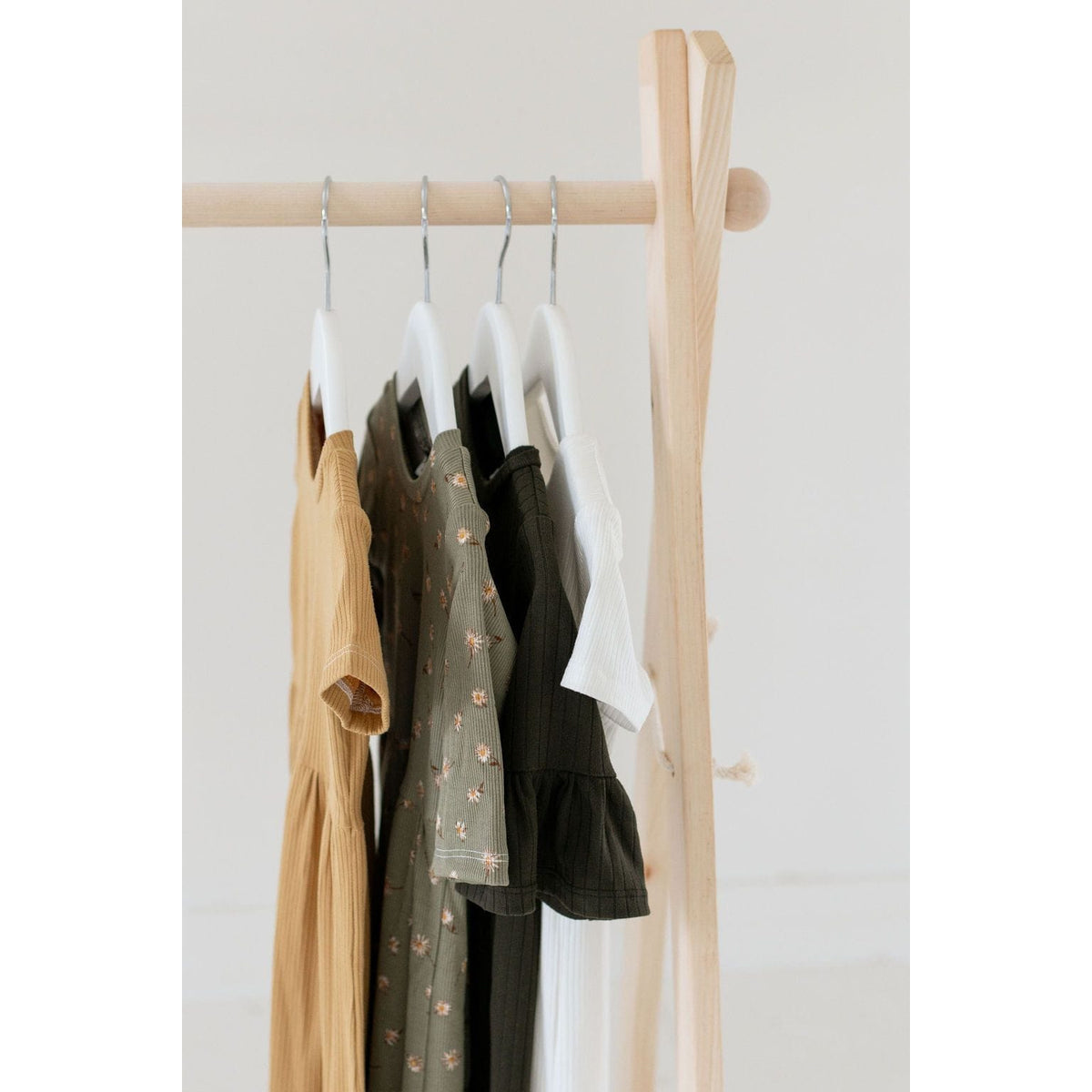 Wooden toddler clothes rack from ShopMyLittleSongbird, featuring a sturdy wooden toy stand for children's clothing storage.