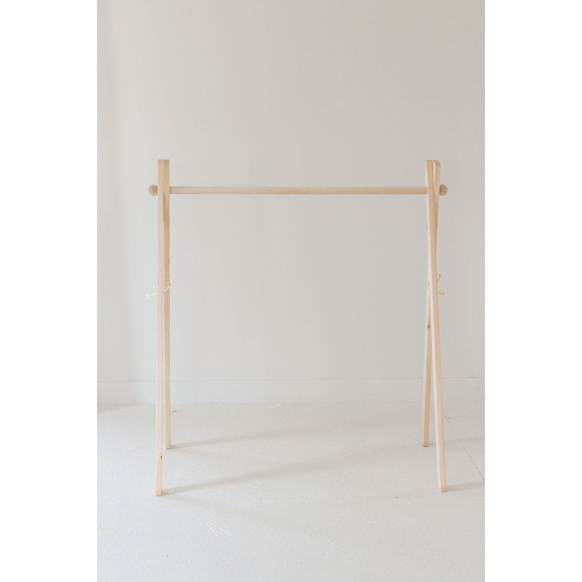 Wooden toddler clothes rack from ShopMyLittleSongbird, featuring a sturdy wooden toy design for organizing children's clothes.