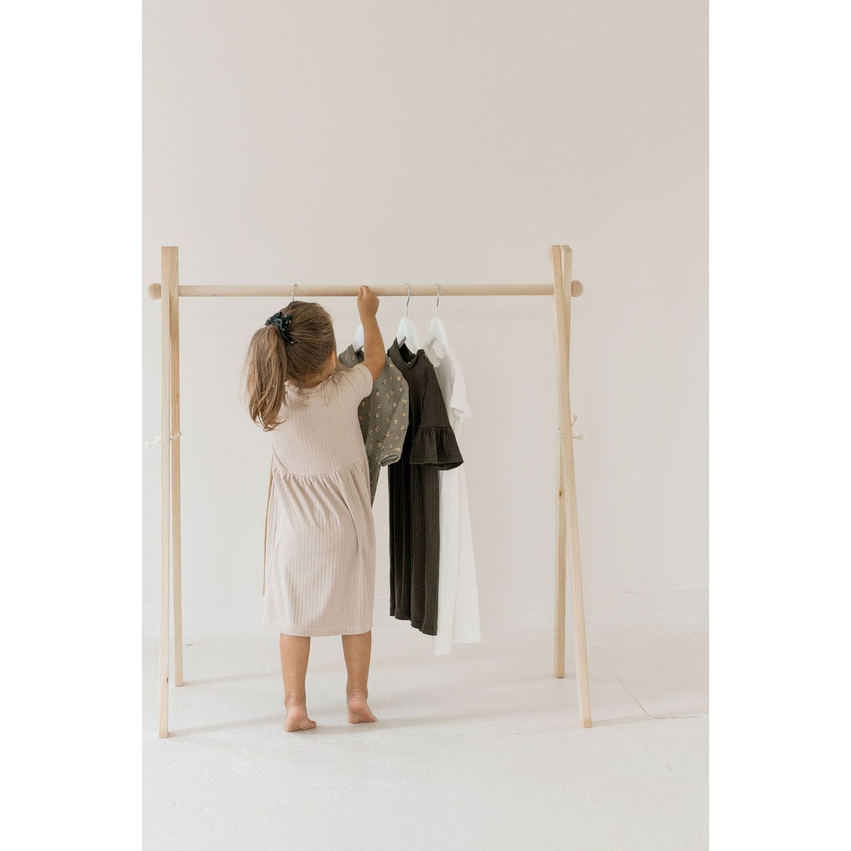 Wooden toddler clothes rack from ShopMyLittleSongbird, designed for organizing children's clothes with a natural wood finish.