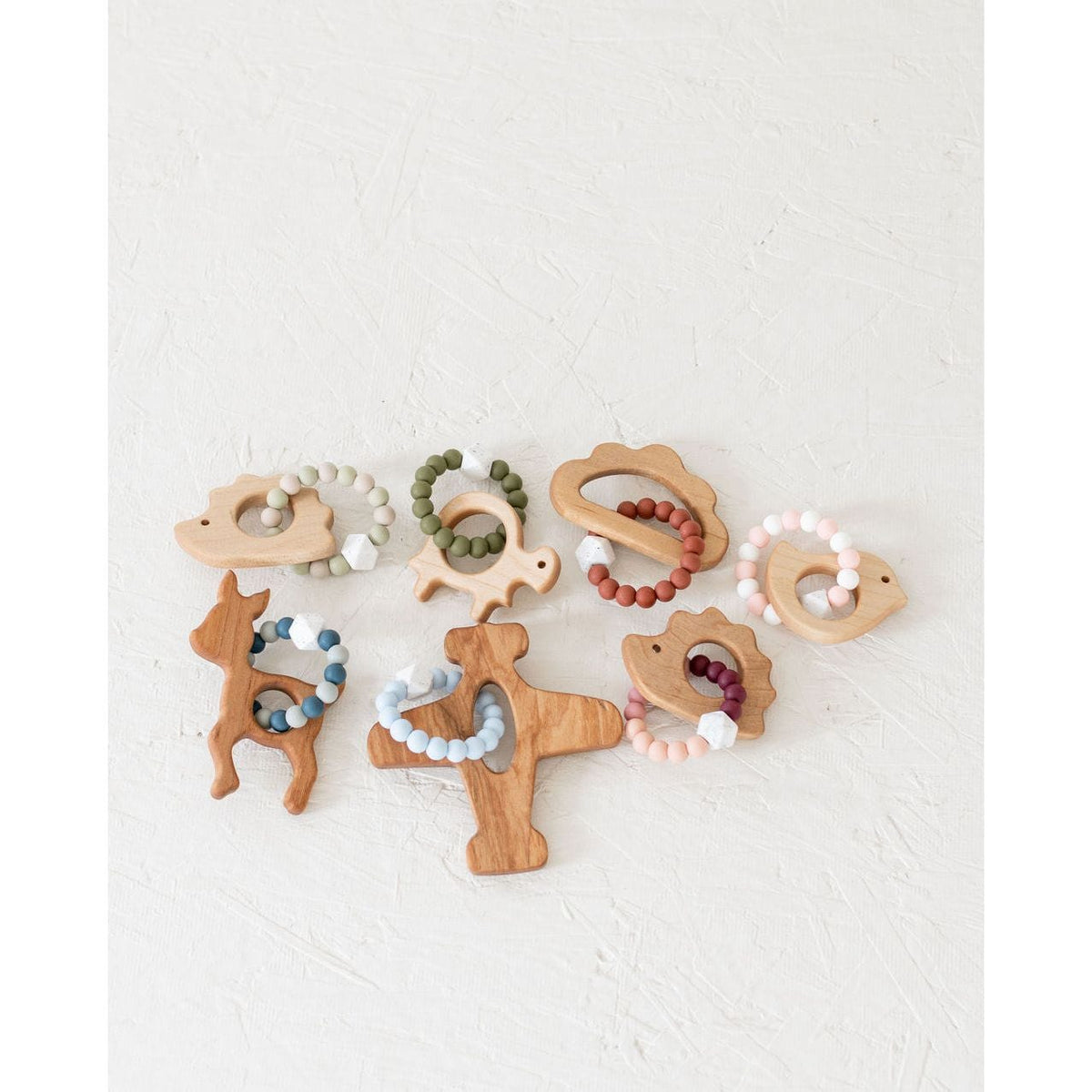 Wooden teether with silicone ring for babies, natural baby teething toy by ShopMyLittleSongbird, showing smooth wooden and silicone surfaces.