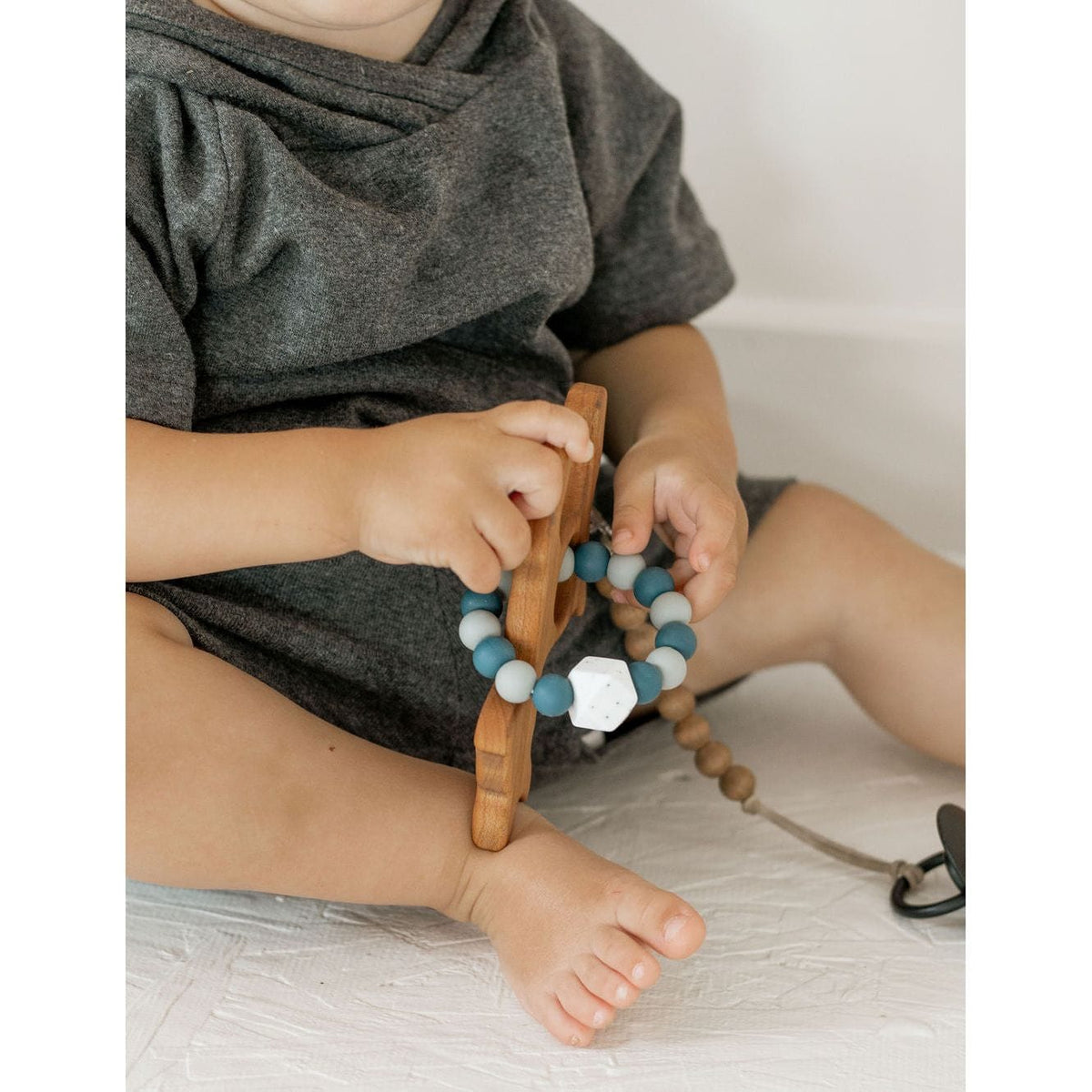Wooden teether with silicone ring for babies, natural teething toy by ShopMyLittleSongbird, safe and soothing for little gums.