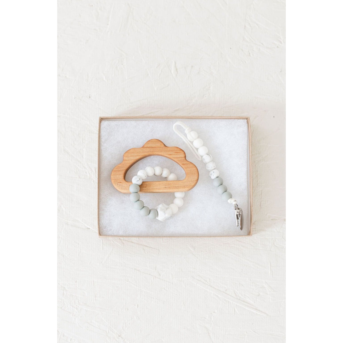 Wooden teether with silicone ring for babies, natural wooden and colorful silicone elements, safe and soothing teething toy.