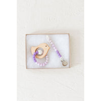 Wooden teether with silicone ring for babies, natural wood and soft silicone detail, designed for soothing teething discomfort.