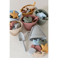 Colorful silicone sand bucket with playful toys and shovel, perfect for kids' outdoor play and beach fun.