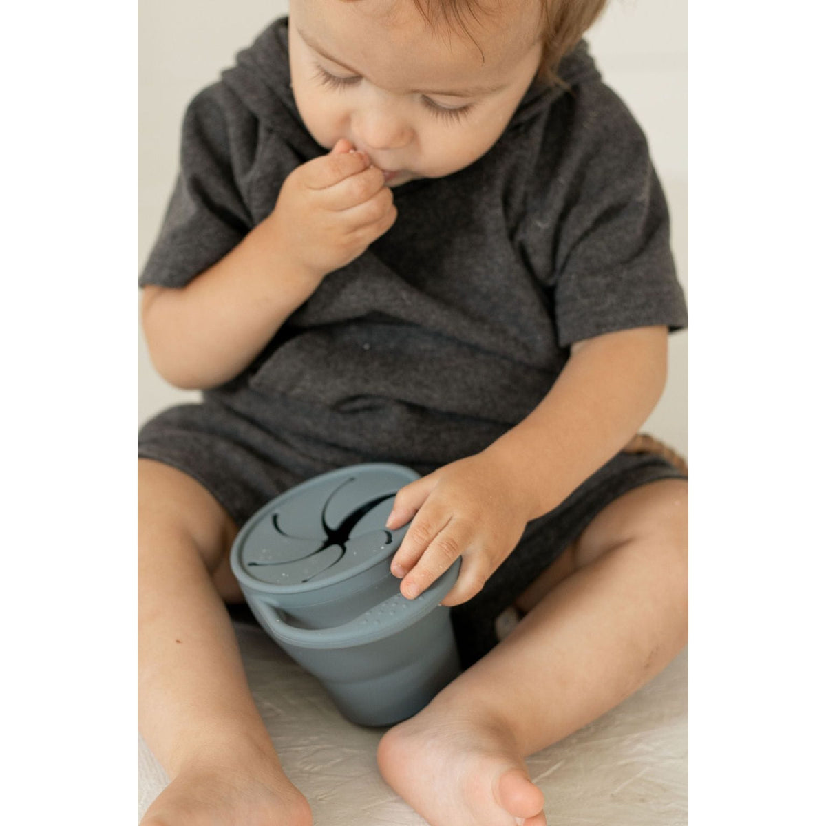 Collapsible silicone snack cup bowl by ShopMyLittleSongbird, flexible and portable for kids' snacks, with bright colors and a secure lid.