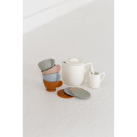 Colorful silicone tea set toy with cups, teapot, and utensils for children, designed for imaginative play.