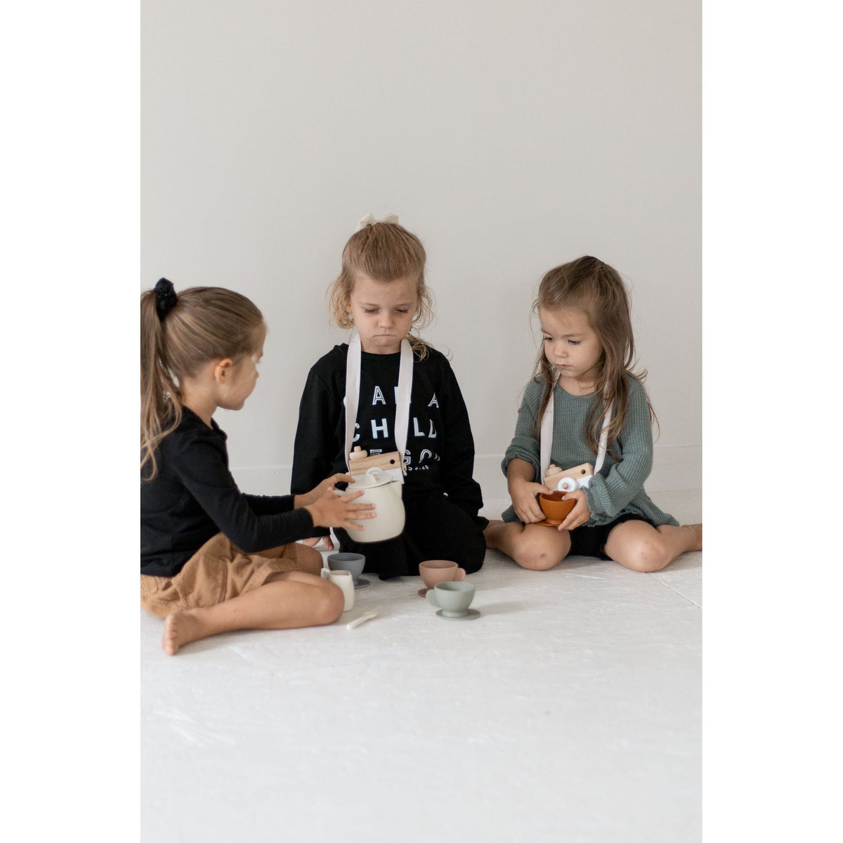 Colorful silicone tea set toy with cups, teapot, and utensils for children, designed for imaginative play.