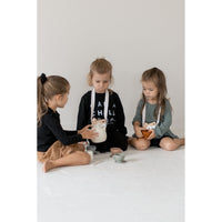 Colorful silicone tea set toy with cups, teapot, and utensils for children, designed for imaginative play.