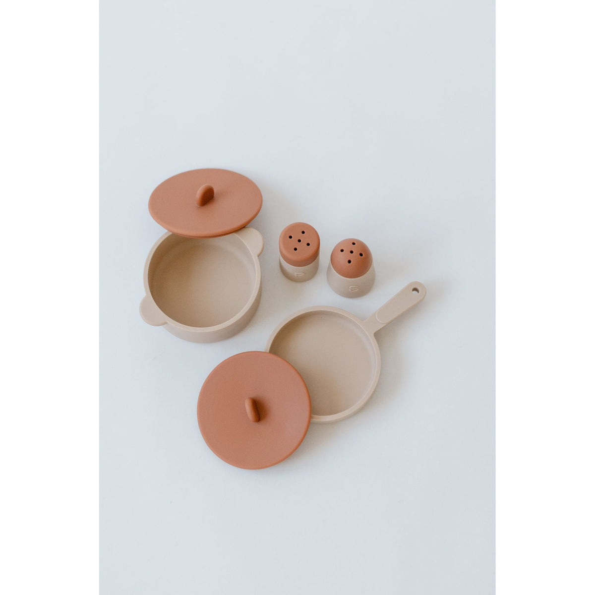 Colorful silicone toy cooking set with pots, pans, and utensils for children, designed for imaginative play.
